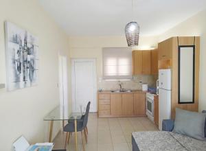 a kitchen with a glass table and a dining room at Holiday & Business Furnished Apartments in Mytikas +12 photos