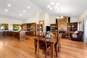 a kitchen and dining room with a table and chairs at Tiverton in Kurrajong