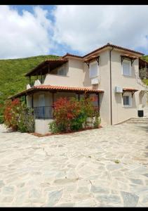 a large house with flowers in front of it at Villa Anemoessa in Kolios