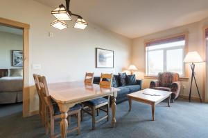 a living room with a table and a couch at Sunstone 325 in Old Mammoth