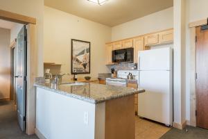 a kitchen with a white refrigerator and a sink at Sunstone 325 in Old Mammoth +16 photos