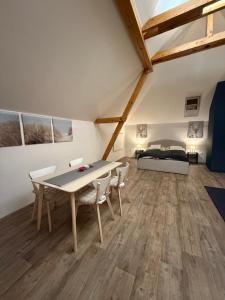 a room with a table and chairs and a bed at Apartmán 19 in Mikulov