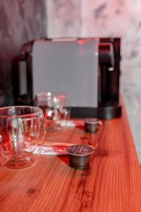 a wooden table with wine glasses and a toaster at Love & Jacuzzi in Bucharest +14 photos