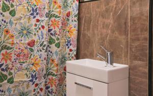 a bathroom with a sink and a shower curtain at KasselRooms Comfort Studio in Kassel