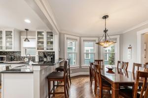 a kitchen and dining room with a table and chairs at Steps to Dtwn Plymouth! Home w/ Dog-Friendly Yard in Plymouth