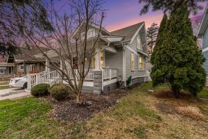 a gray house with a porch and a tree at Steps to Dtwn Plymouth! Home w/ Dog-Friendly Yard in Plymouth