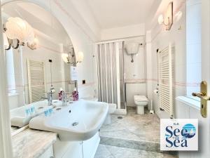 a white bathroom with a sink and a toilet at See The Sea B&B in Salerno +45 photos