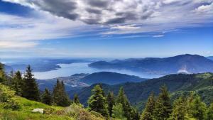 a view of a valley in the mountains with a lake at Casetta dei Lupi in Miazzina