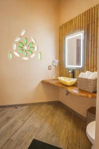 a bathroom with a sink and a mirror at Bambu Villas Wellness Center in Amatlán