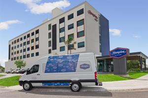 a white van parked in front of a building at Hampton By Hilton Guanacaste Airport in Liberia +83 photos