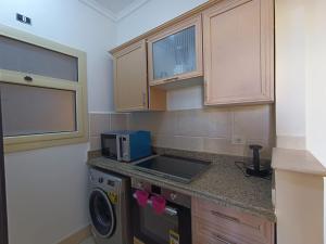 a kitchen with a sink and a washing machine at OrientalCoast in Quseir
