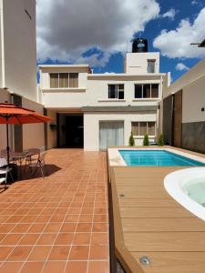 a house with a swimming pool and a building at Refugio del Turista in Tupiza