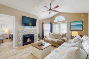 a living room with a couch and a fireplace at Beach Club: The Lighthouse in Padre Island