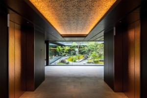 an empty hallway in a building with a large window at Hilton Kyoto in Kyoto