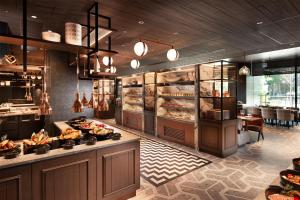 a restaurant with a buffet with bread and pastries at Hilton Kyoto in Kyoto