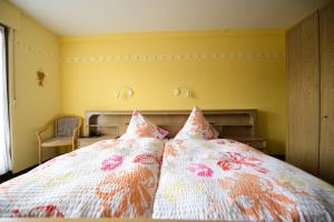 a bedroom with a bed with two pillows on it at Landgasthaus Pension Schmidthöfer in Berschweiler +3 photos