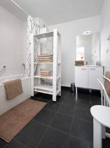 a bathroom with a tub and a table and a sink at Le Clos Savignac in Trouville-sur-Mer +8 photos