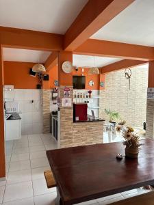 a kitchen with a wooden table in a room at Pousada ExtraLar in Fortaleza