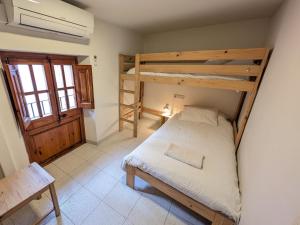 a bedroom with two bunk beds in a room at Ca la iaia - Turisme familiar in Amer +13 photos