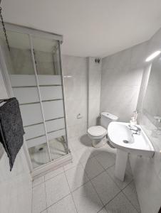 a white bathroom with a toilet and a sink at Ca la iaia - Turisme familiar in Amer