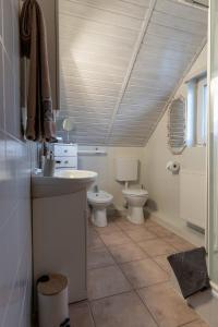a bathroom with a sink and a toilet at Lagom Vendégház in Zalaszentgrót +26 photos