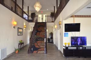 a hallway with a spiral staircase with a tv on it at Days Inn by Wyndham Trumann AR in Trumann