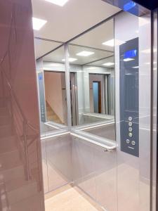 a glass shower with mirrors in a room at Hotel BlueTwo Međugorje in Međugorje