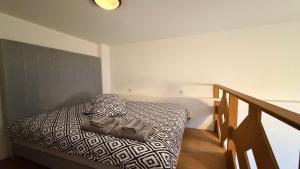 a bedroom with a bed with a purse on it at Loft in Viljandi Old Town in Viljandi