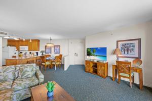 a living room and kitchen with a couch and a table at Kaanapali Shores 512 in Kaanapali