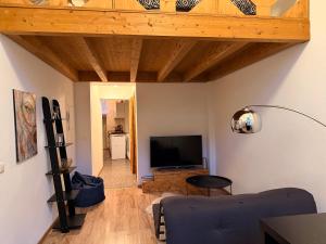 a living room with a couch and a television at Loft in Viljandi Old Town in Viljandi