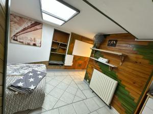 a room with a bed and a wall of wood at Appartement familial de 60 M2 in Angoulême