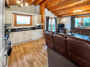 a kitchen with brown leather seats in a room at Avocet Lodge in Horncastle