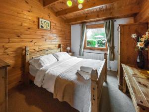a bedroom with a bed in a wooden cabin at Avocet Lodge in Horncastle