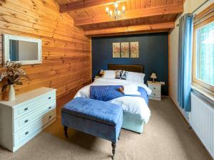 a bedroom with a bed and a desk and a tv at Avocet Lodge in Horncastle +8 photos