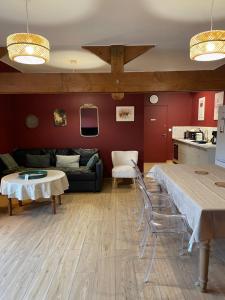 a living room with a couch and a table and chairs at Le Clos d Emilie in Saint-Marcel