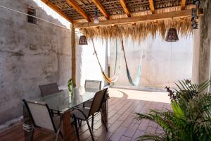 a dining room with a glass table and chairs at Suku'un in Brisas de Zicatela