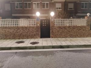 a building with two manholes on the side of a street at APARTAMENTO COSTA CANTABRIA in Cuchia