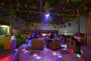 a group of people sitting in a room with lights at Five Palms Hotel in Gurgaon