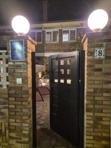 a door in a brick wall with lights on it at APARTAMENTO COSTA CANTABRIA in Cuchia