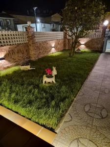 a fake horse in the grass with flowers on it at APARTAMENTO COSTA CANTABRIA in Cuchia +58 photos
