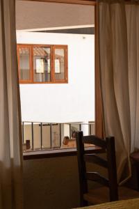 ein Blick auf einen Balkon aus einem Fenster mit einem Stuhl in der Unterkunft Hotel Morada de Paz in Colorines