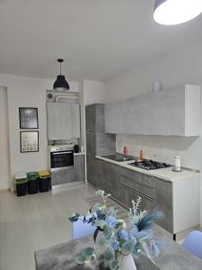a kitchen with a sink and a stove at Casa Roncalli 19-A in Foligno