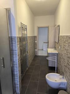 a bathroom with a sink and a toilet and a shower at Casa Roncalli 19-A in Foligno
