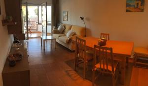 a living room with a table and a couch at Coma-ruga in Comarruga