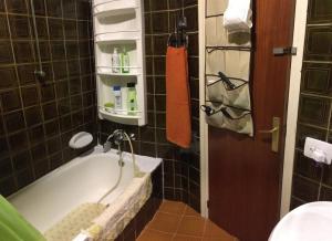 a bathroom with a bath tub with a faucet at Coma-ruga in Comarruga +8 photos