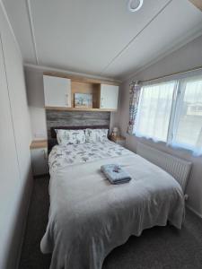 a bedroom with a large bed and a window at Pine Ridge B6 in Reighton +32 photos