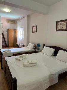 two beds in a bedroom with towels on them at Themis Apartment in Kotor +80 photos