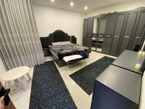 a bedroom with a bed and a table and chairs at Cartier in Baghdād