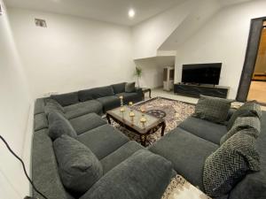 a living room with a large couch and a table at Cartier in Baghdād