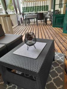 a patio with a table and chairs on a deck at Dalmacia Idyll mobilházak Privlaka in Privlaka